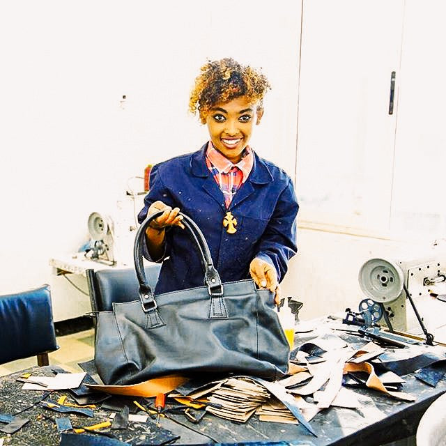 woman smiling in leather workshop in Ethiopia
